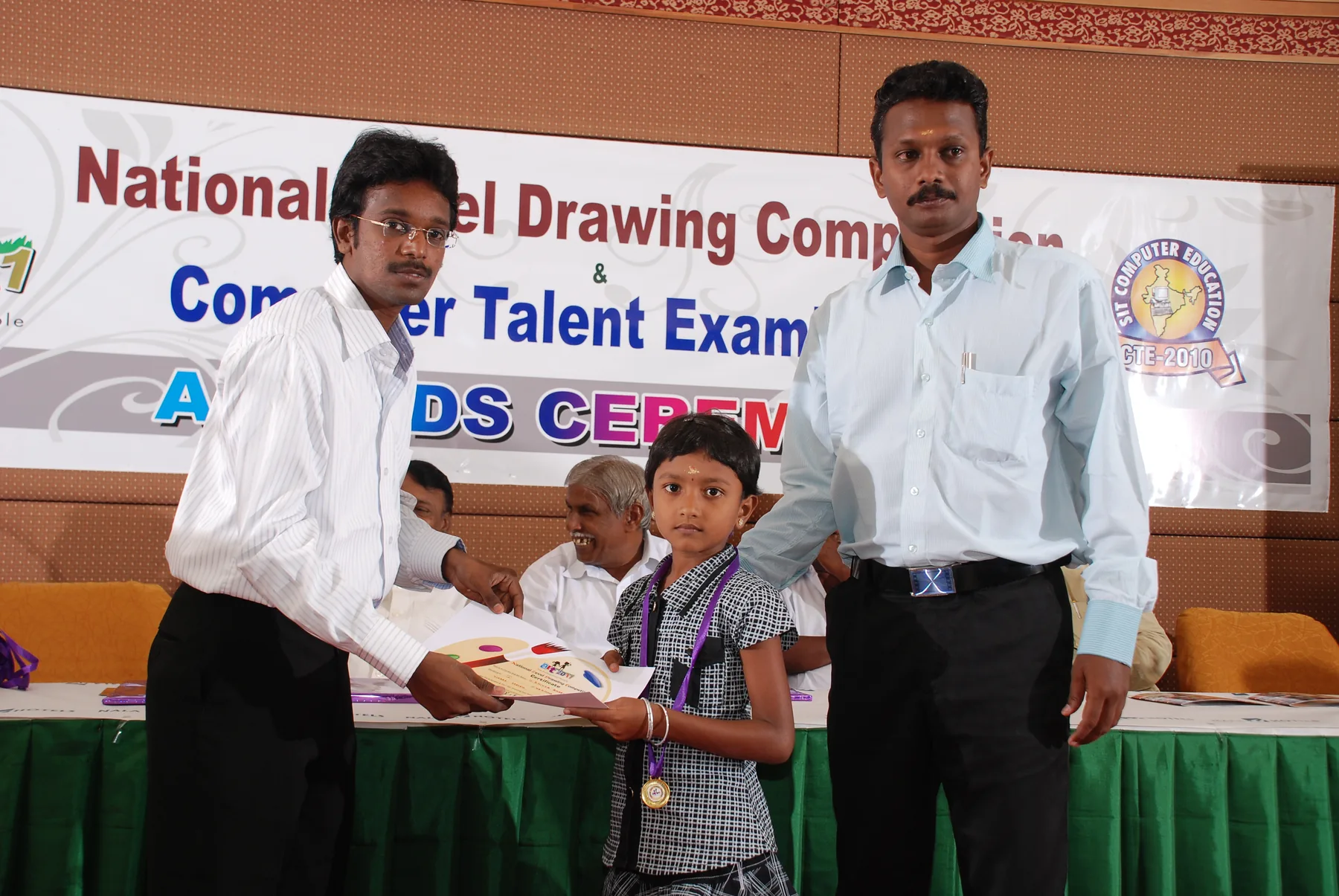 A young artist receives her certificate, documented by The ART Foundation in 2011