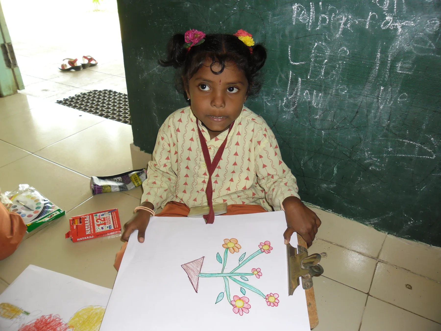 A young student begins her drawing, documented by The ART Foundation